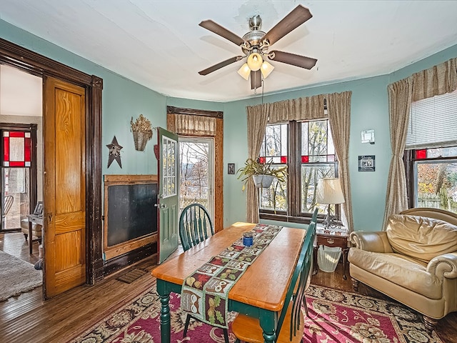 dining area featuring ceiling fan and wood-type flooring