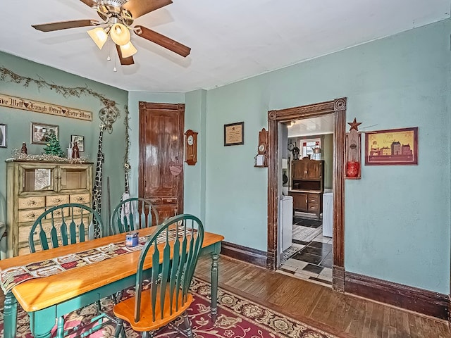 dining area featuring ceiling fan and dark hardwood / wood-style flooring