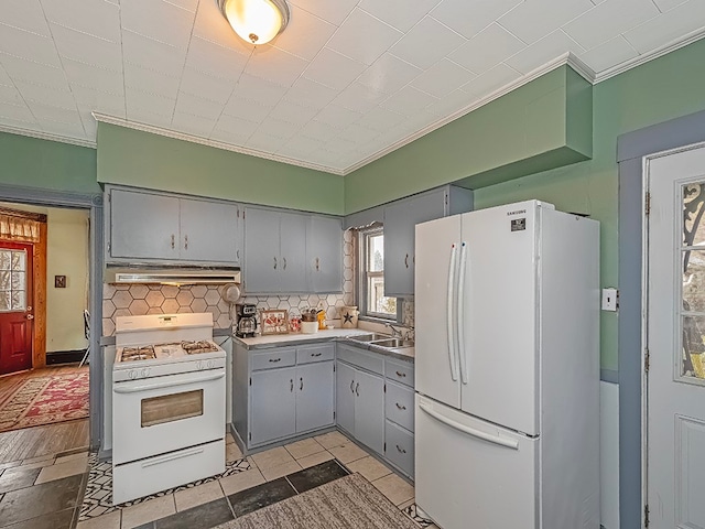 kitchen with white appliances, extractor fan, ornamental molding, and backsplash