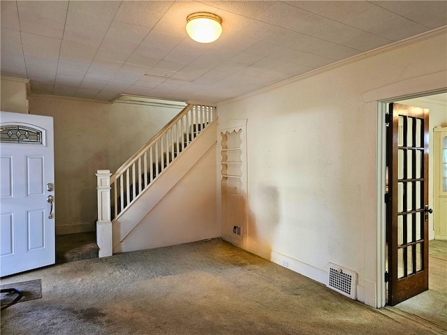 interior space featuring ornamental molding and carpet flooring