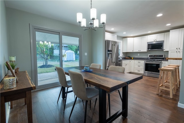 dining room featuring dark hardwood / wood-style flooring and an inviting chandelier