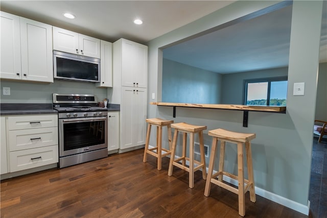 kitchen featuring white cabinetry, dark wood-type flooring, and appliances with stainless steel finishes