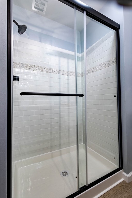 bathroom featuring hardwood / wood-style floors and walk in shower