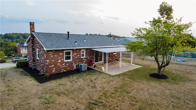 back of house with a patio area, a yard, and cooling unit