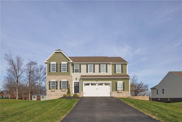 colonial-style house featuring a front lawn and a garage