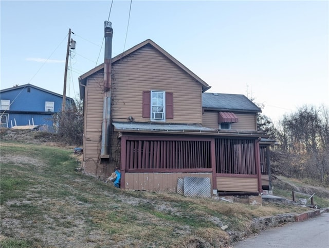 rear view of property featuring a yard