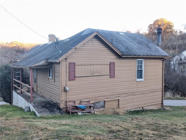 view of property exterior with a yard