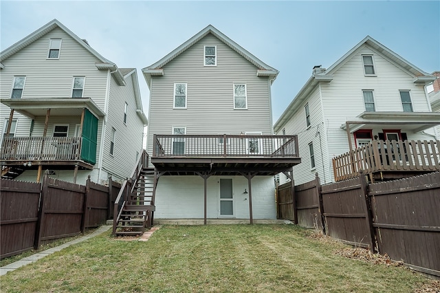 back of property with a lawn and a wooden deck