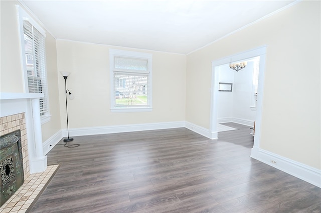 unfurnished living room with a fireplace, dark hardwood / wood-style floors, and ornamental molding