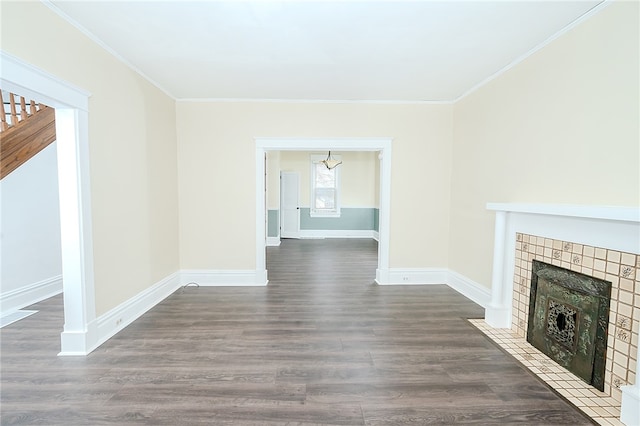 unfurnished living room featuring dark hardwood / wood-style flooring and ornamental molding