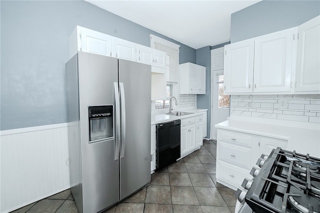 kitchen featuring backsplash, white cabinetry, sink, and appliances with stainless steel finishes