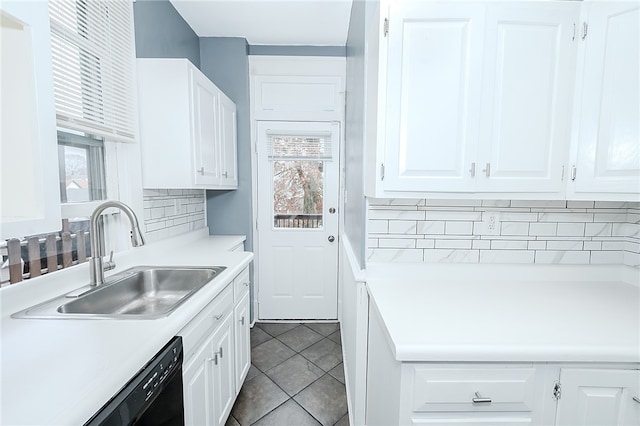 kitchen with backsplash, plenty of natural light, white cabinetry, and sink