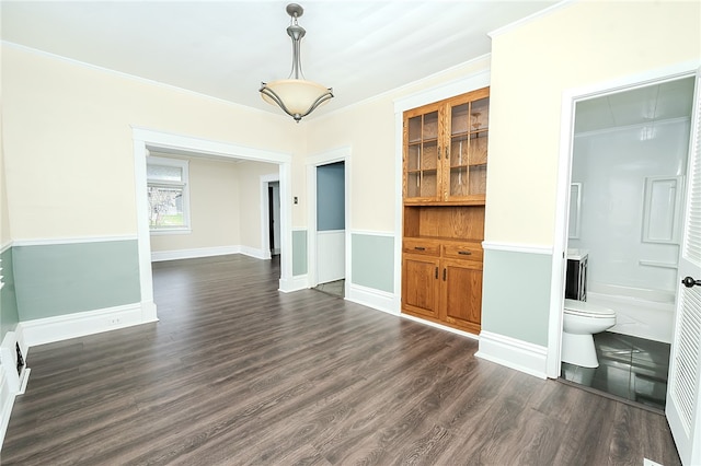 interior space featuring dark hardwood / wood-style flooring and ornamental molding