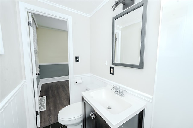 bathroom featuring hardwood / wood-style floors, vanity, toilet, and ornamental molding