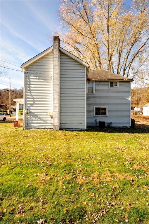 view of property exterior with a lawn