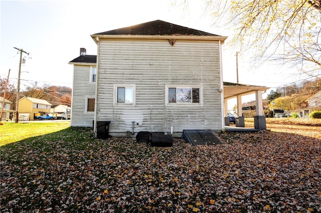 view of side of home with a lawn