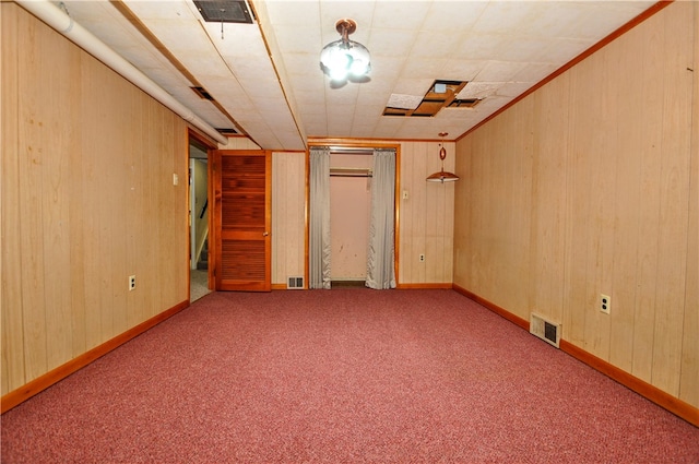 interior space with light colored carpet and wooden walls