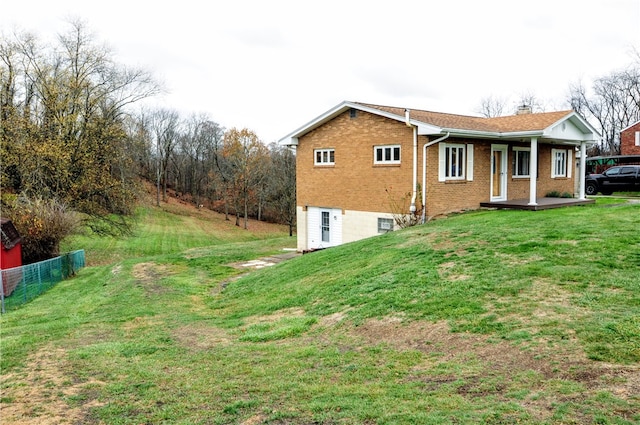 view of side of home with a yard