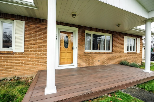 view of exterior entry featuring a deck