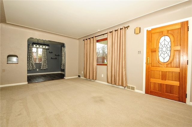 view of carpeted entrance foyer