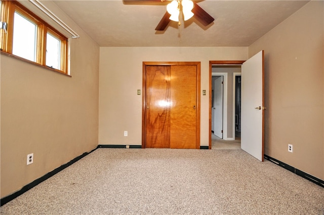 interior space featuring ceiling fan and carpet floors