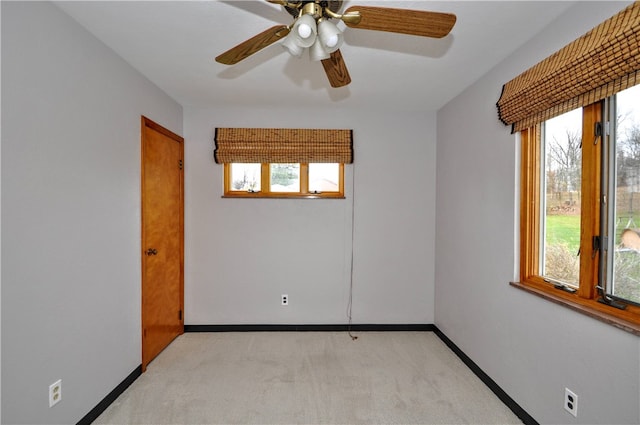 unfurnished room featuring light colored carpet and a wealth of natural light