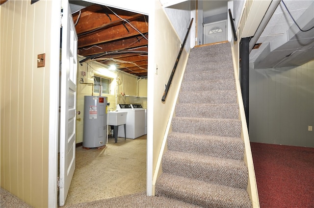 staircase with carpet flooring, water heater, and washer and dryer