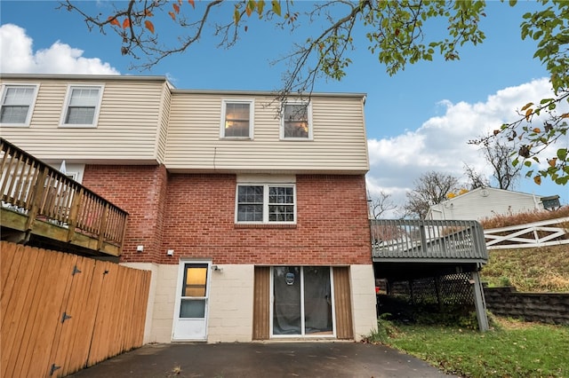 rear view of property with a wooden deck