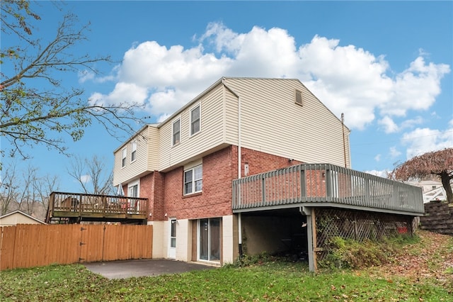 rear view of house with a deck and a patio area