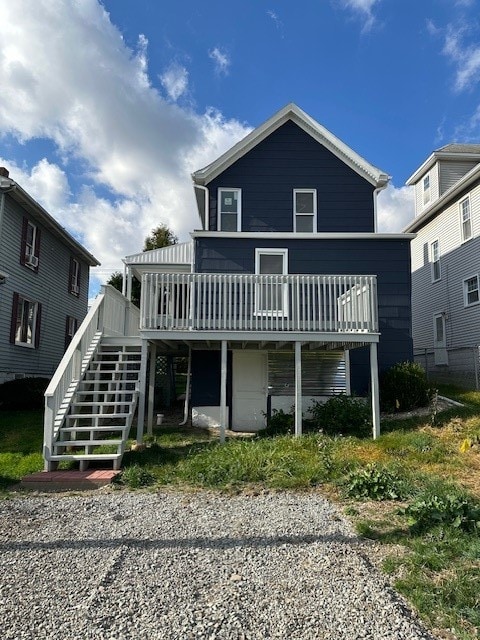 rear view of property featuring a wooden deck