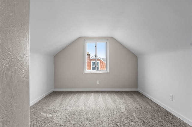 additional living space with carpet and lofted ceiling