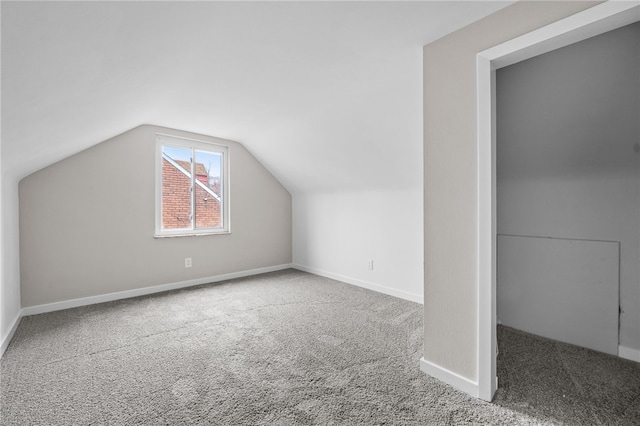 bonus room with carpet flooring and lofted ceiling