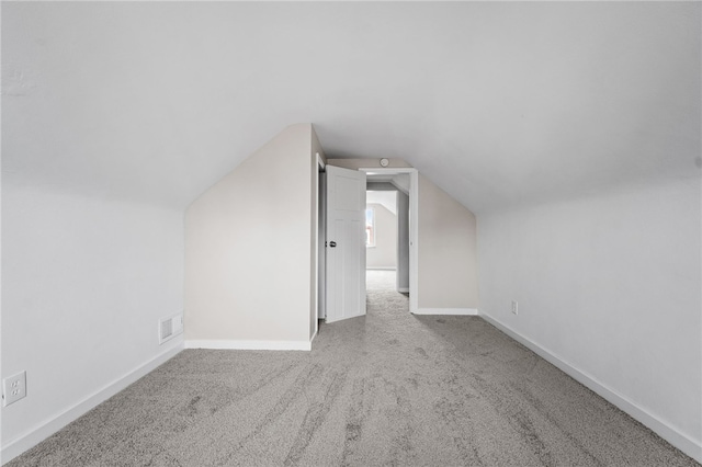 bonus room featuring light carpet and lofted ceiling