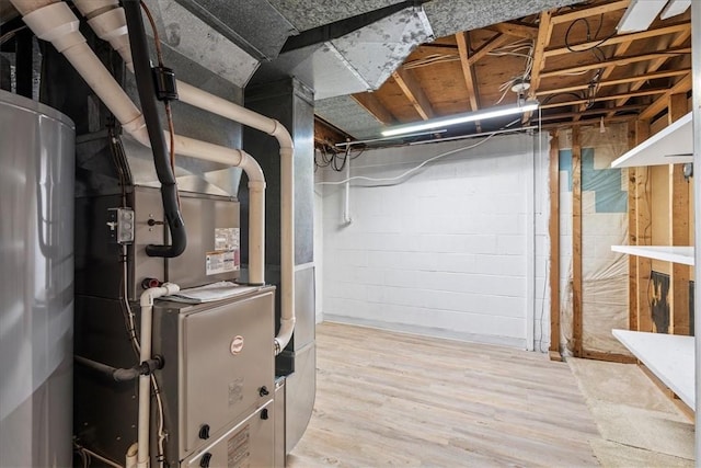 basement featuring wood-type flooring and heating unit