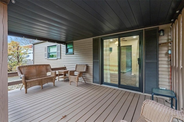 wooden terrace with an outdoor living space