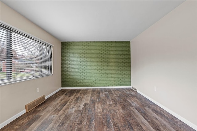 empty room featuring dark wood-type flooring