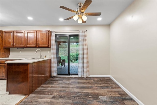 kitchen featuring hardwood / wood-style flooring, ceiling fan, and sink