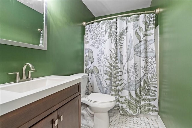 bathroom with tile patterned floors, vanity, and toilet