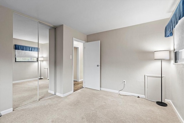 unfurnished bedroom featuring carpet flooring and a closet