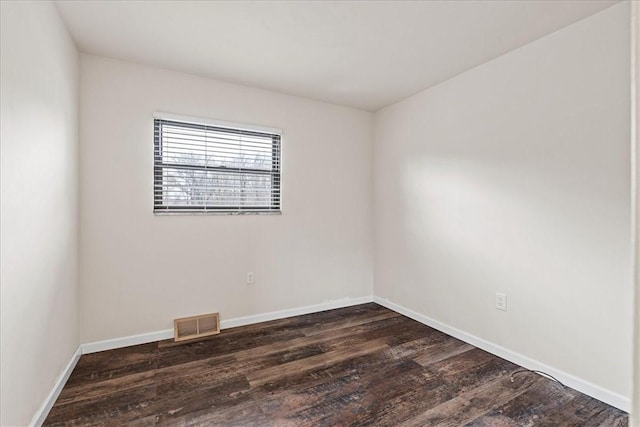 empty room featuring dark wood-type flooring