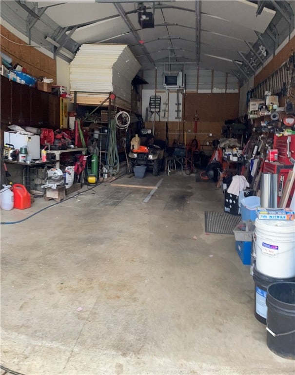 garage with a workshop area and a garage door opener