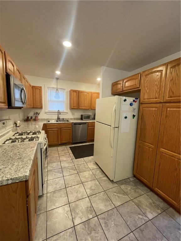 kitchen featuring light tile patterned floors, stainless steel appliances, and sink