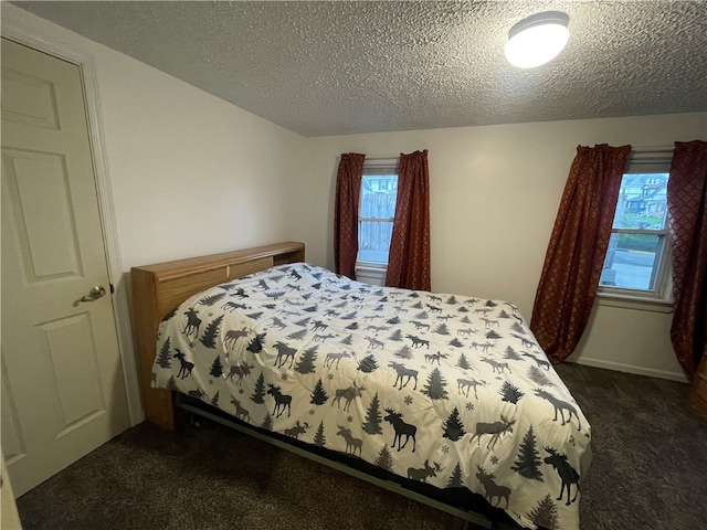 carpeted bedroom with a textured ceiling