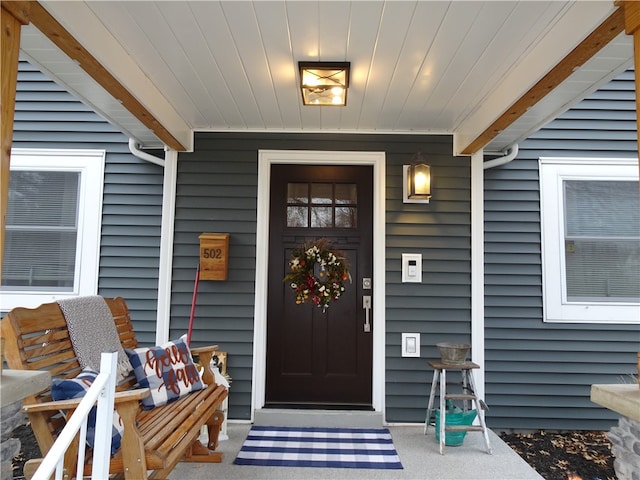 view of exterior entry featuring a porch