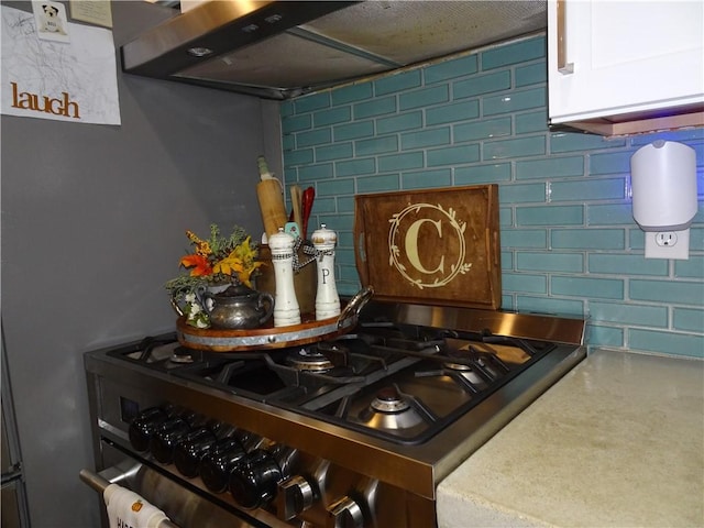 kitchen featuring ventilation hood and white cabinets