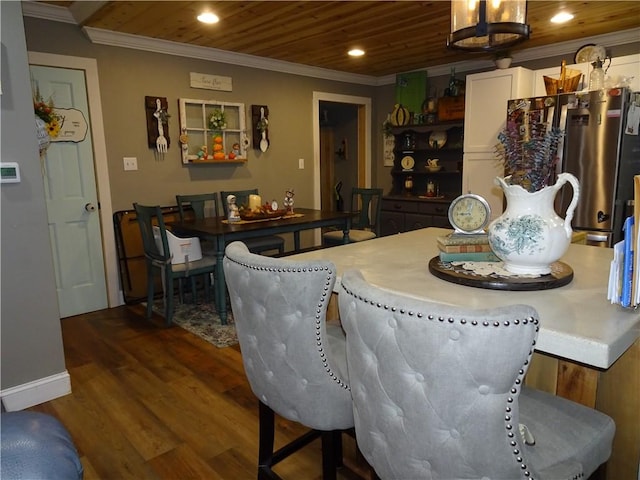 dining room with dark hardwood / wood-style flooring, wooden ceiling, an inviting chandelier, and ornamental molding