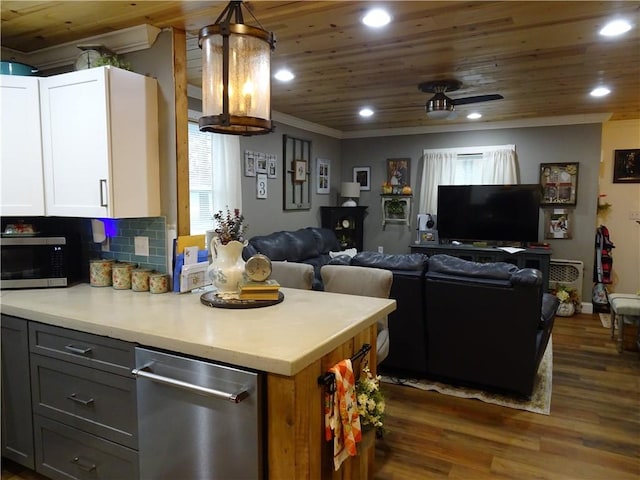 kitchen featuring decorative light fixtures, gray cabinets, decorative backsplash, white cabinets, and appliances with stainless steel finishes