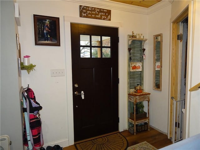 foyer with hardwood / wood-style flooring and ornamental molding