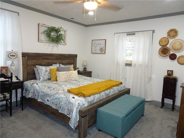 carpeted bedroom featuring ceiling fan and crown molding