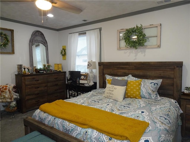 carpeted bedroom featuring ceiling fan and crown molding